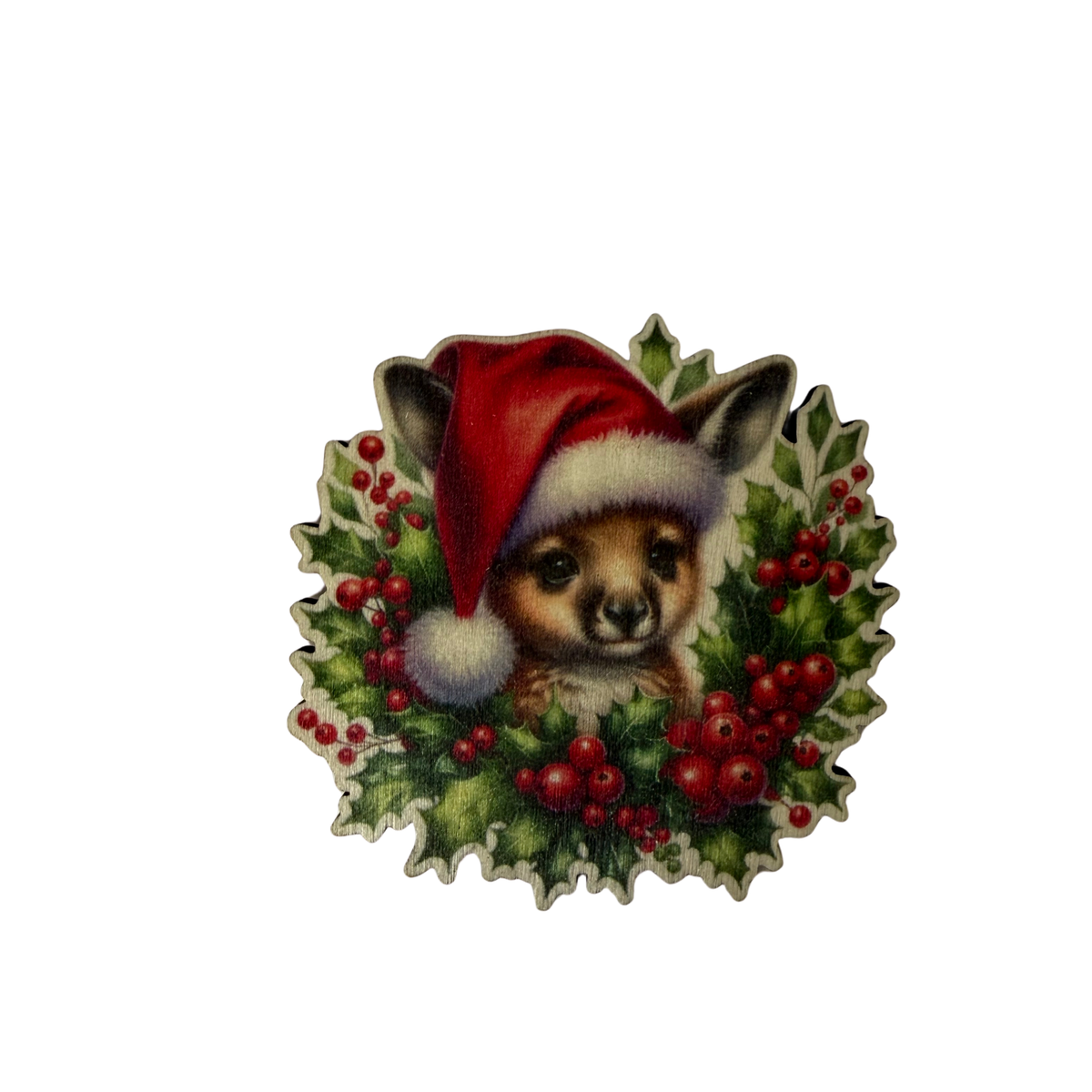 Wooden wallaby Christmas ornament wearing a red Santa hat, surrounded by green foliage and red berries on a white background.