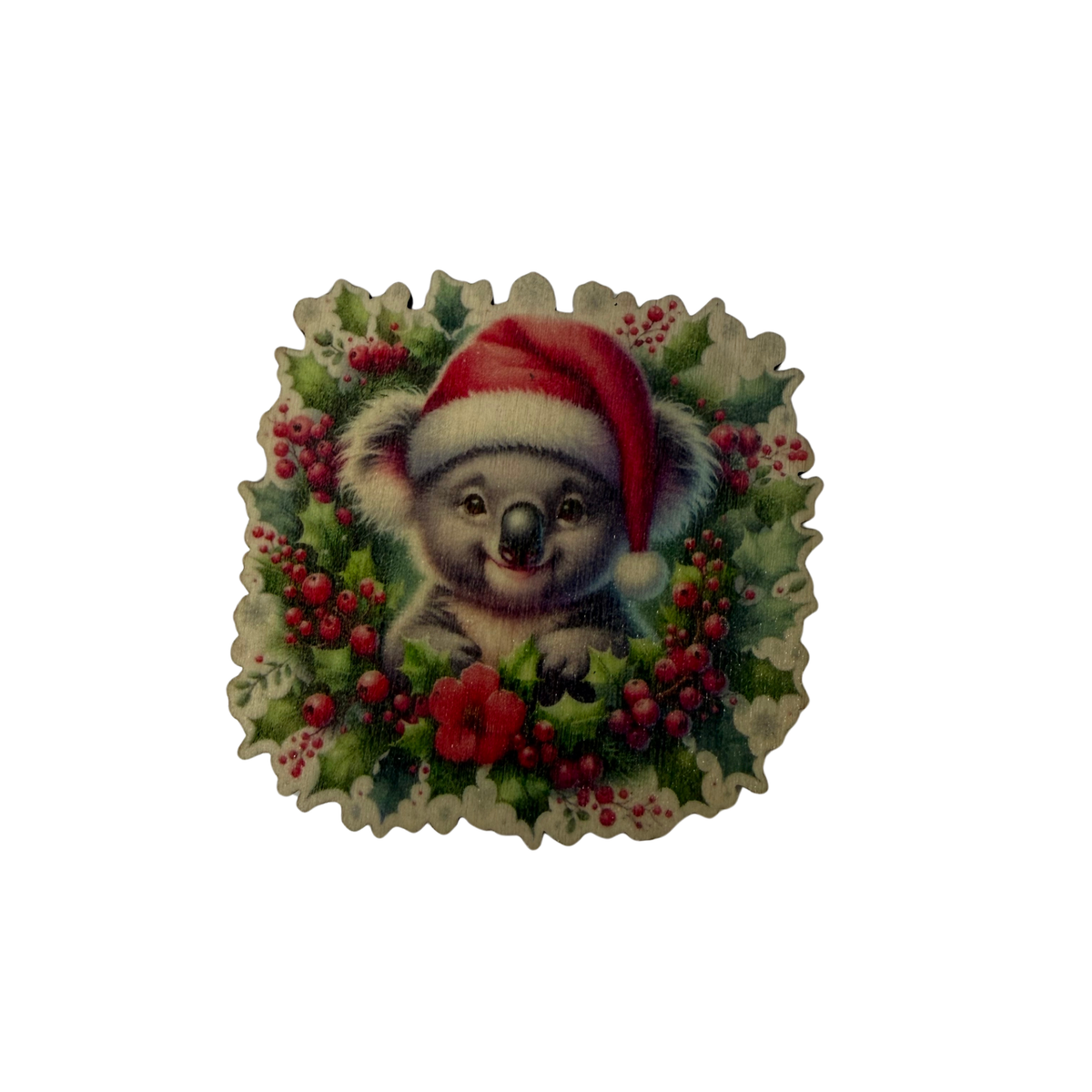 Wooden koala Christmas magnet featuring a koala in a Santa hat surrounded by festive greenery and red berries
