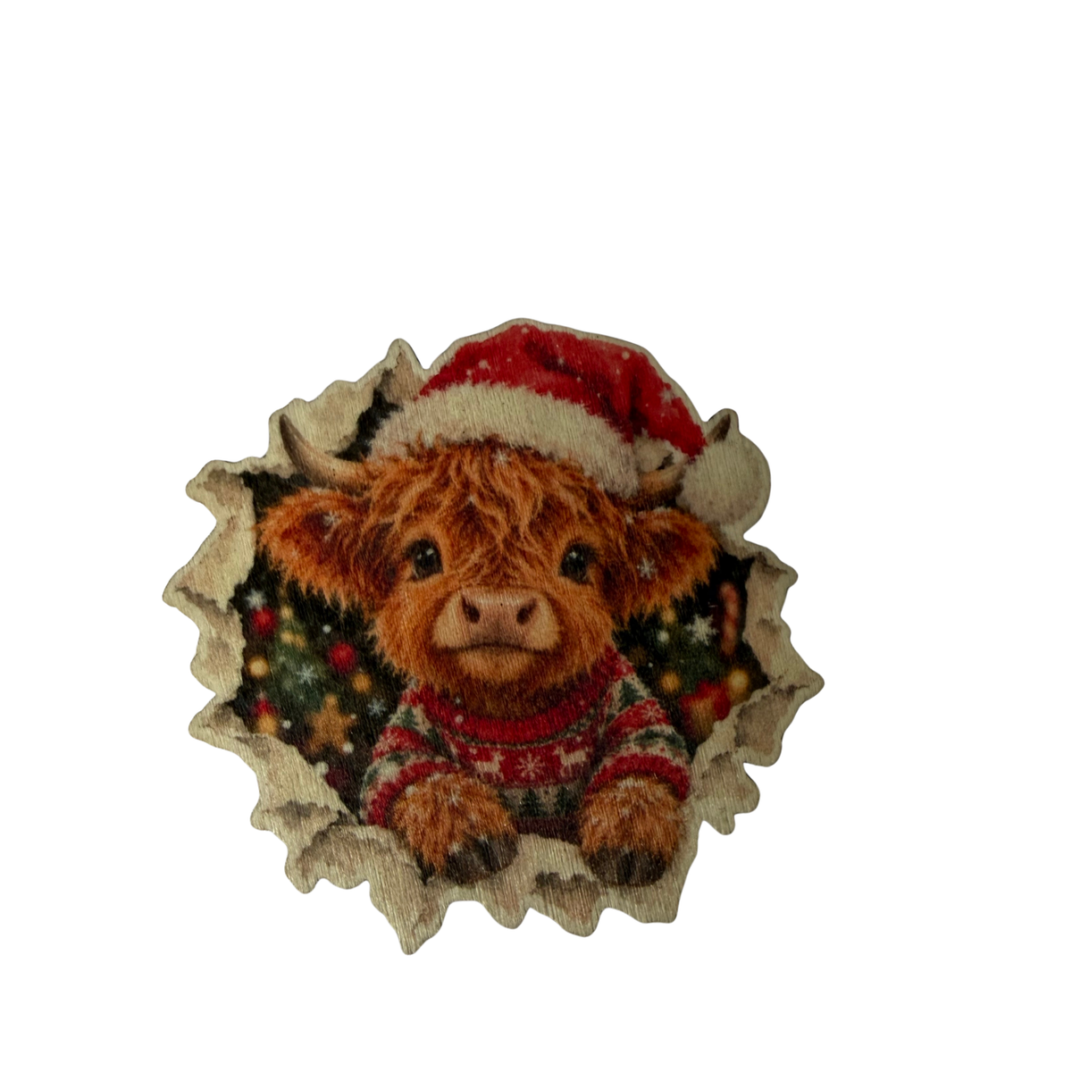 Wooden Highland cow Christmas magnet wearing a red Santa hat and patterned festive jumper, with Christmas trees behind it on a white background.