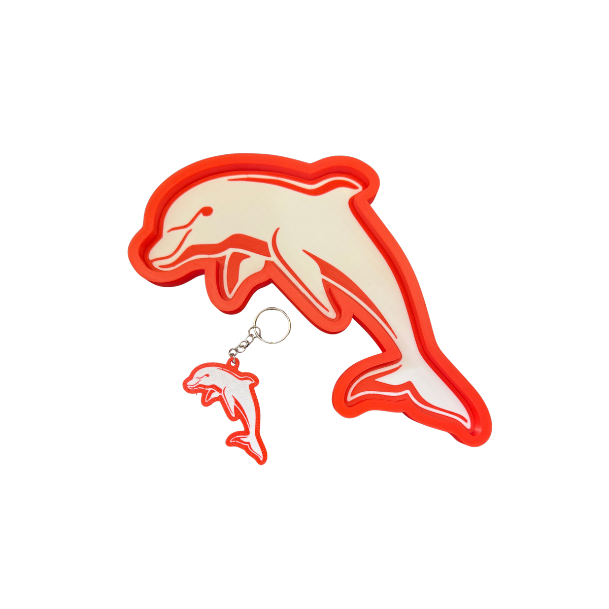 Dolphins-inspired red and cream trinket tray and matching keyring on a white background