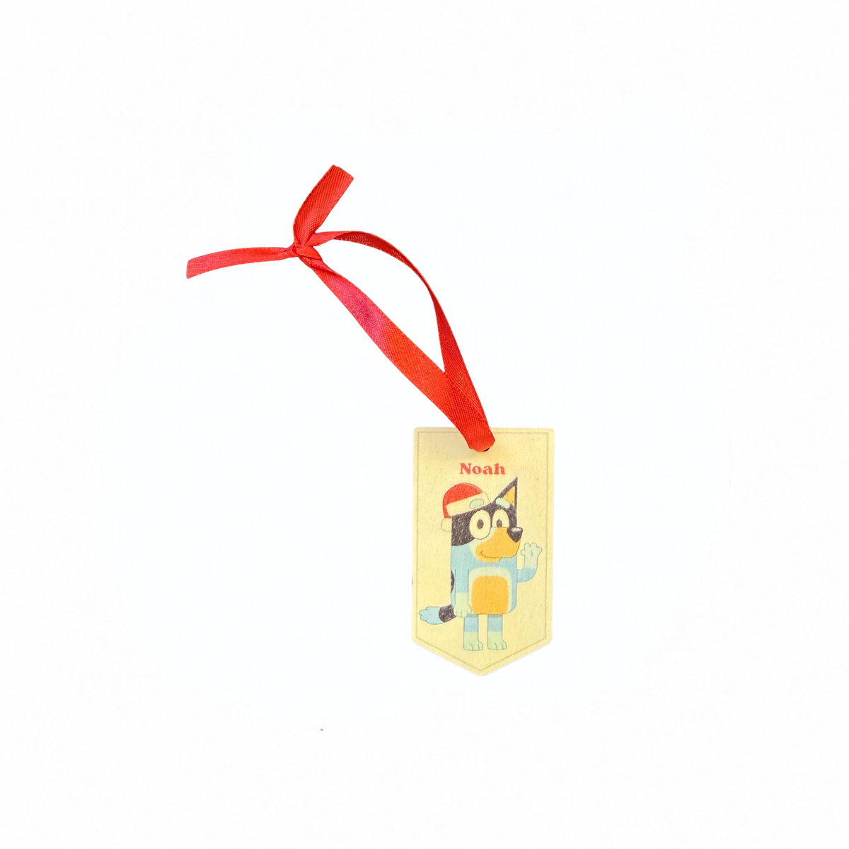 Personalised Bluey Christmas ornament with a Bluey character in a Santa hat on a cream banner with a red ribbon