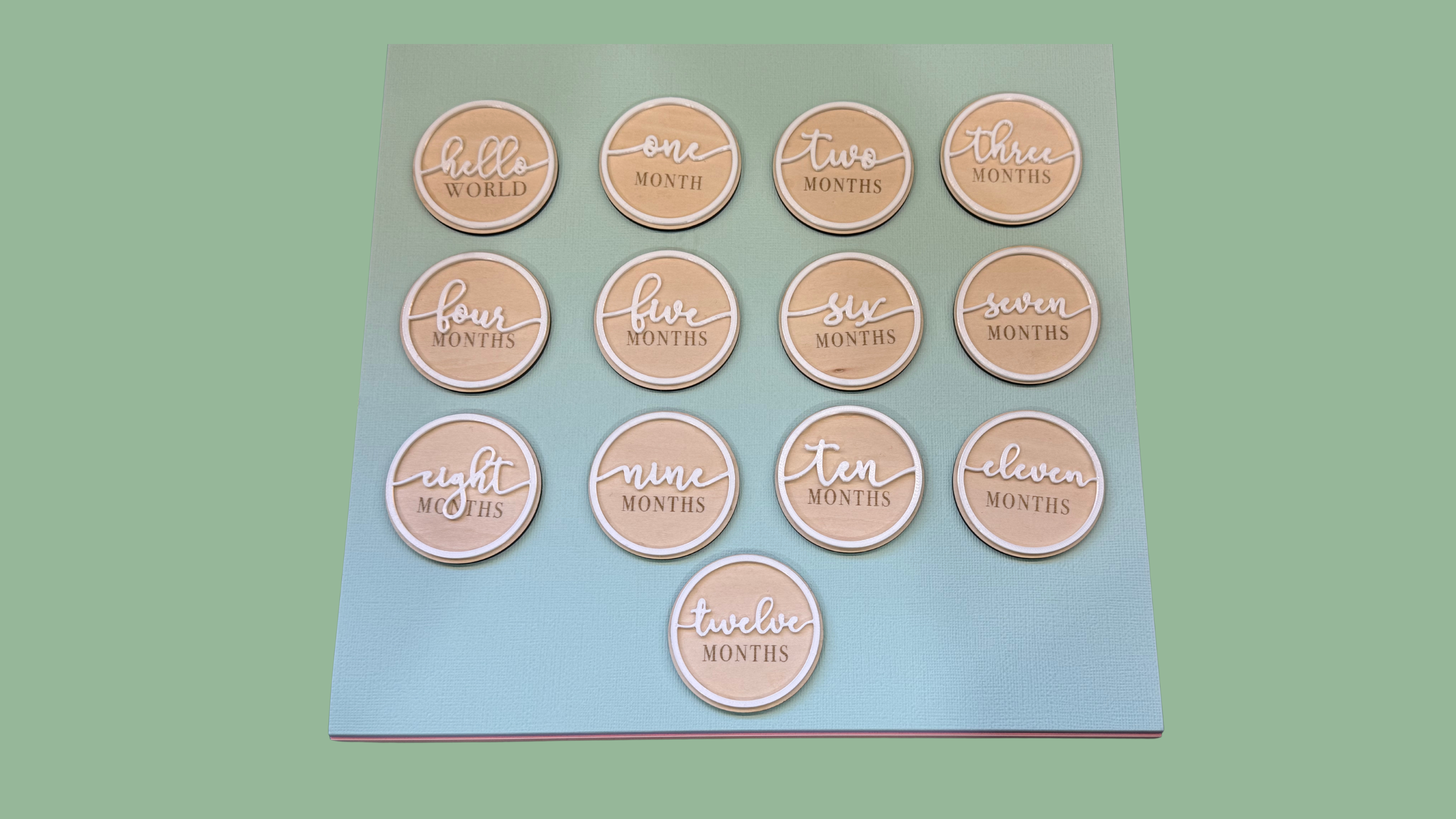Wooden baby milestone marker discs engraved Hello World through twelve months